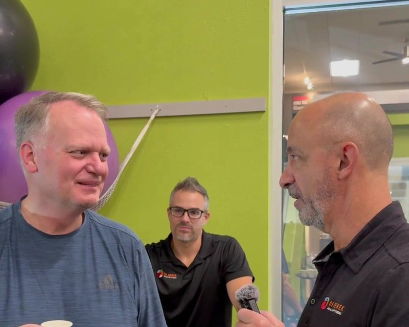 Dr. Derek with a client at his clinic
